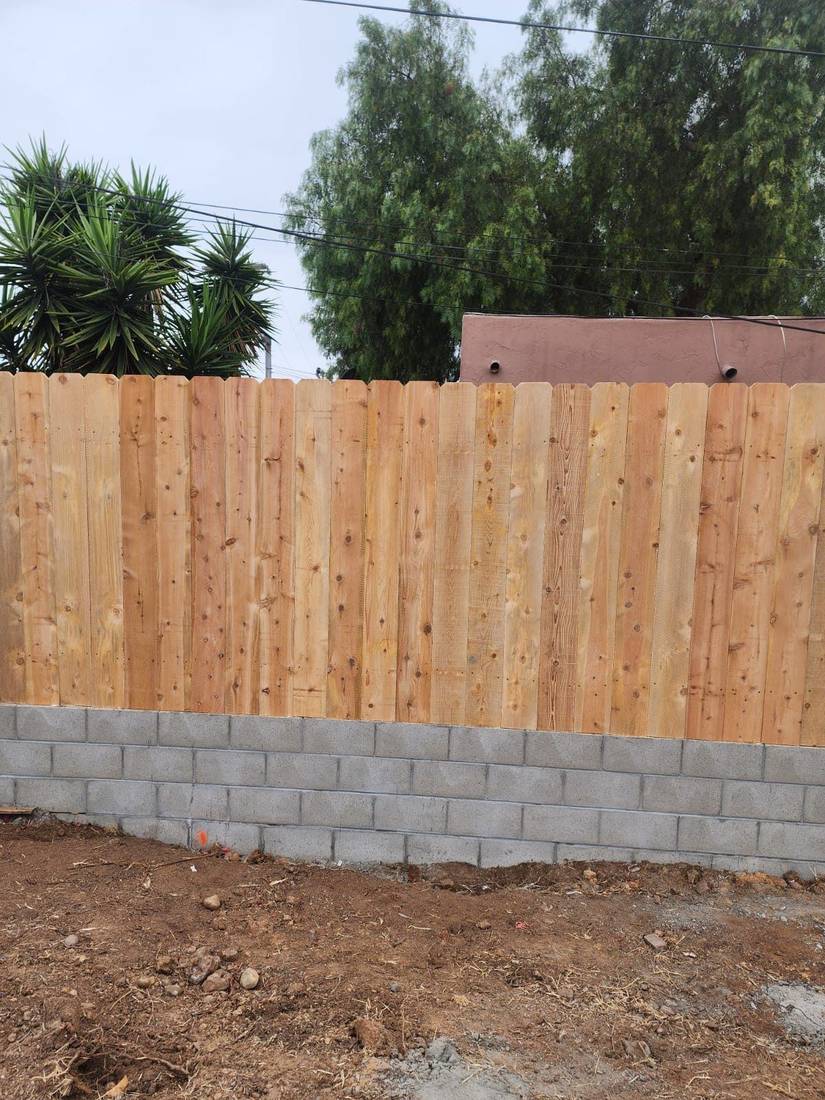 New wood fence on a block wall foundation in a San Diego property — Benitez Tree Service