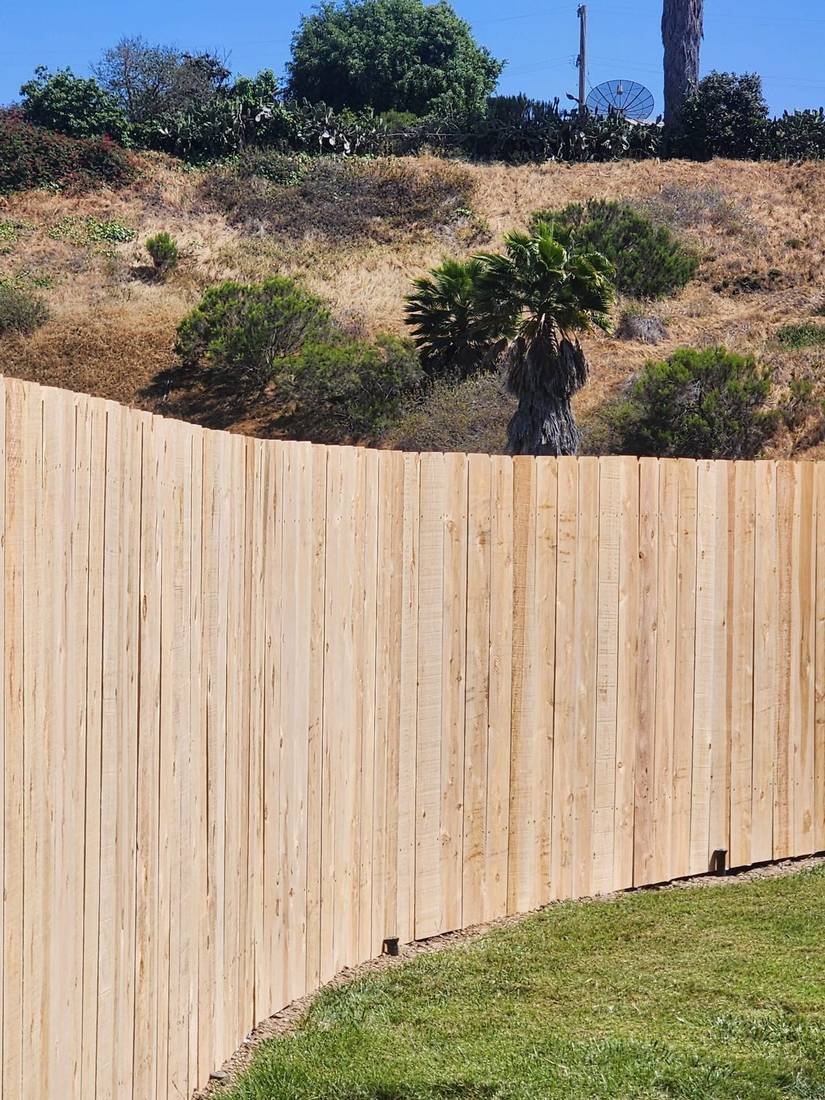 New cedar fence along a hillside property in San Diego — Benitez Tree Service