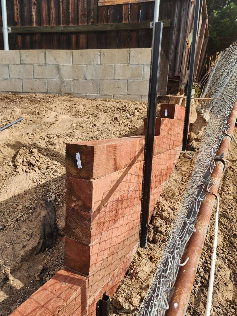 New redwood fence posts set with chain-link tie-in — Benitez Tree Service